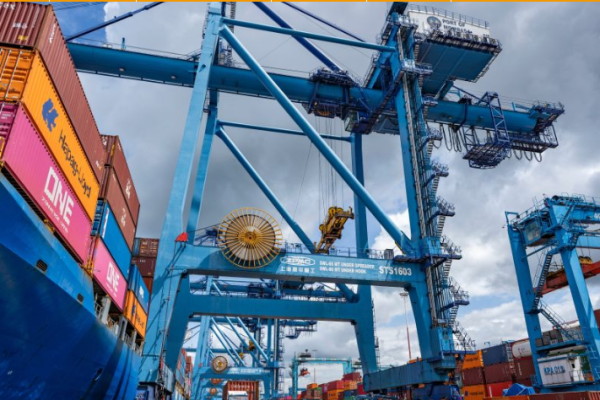 A crane hoists containers at the Port of Mombasa in Mombasa