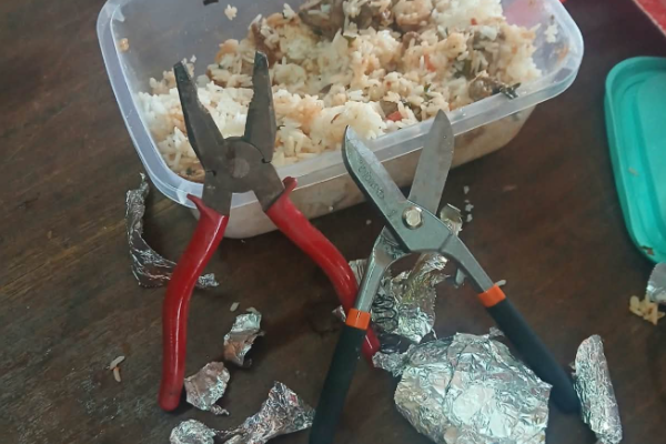 A pair of pliers and a pair of shears hidden beneath the food. PHOTO/DCI_Kenya