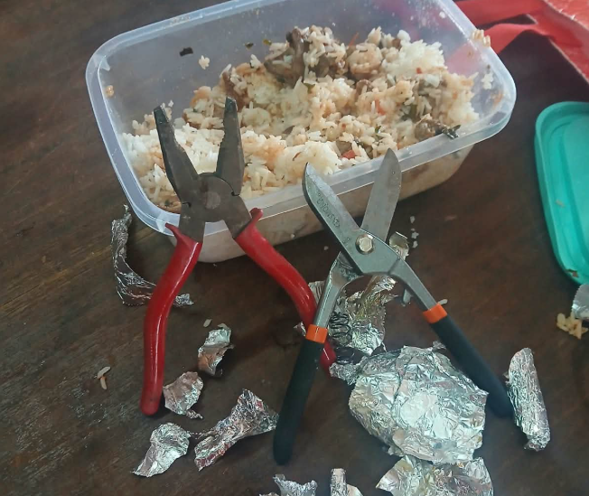 A pair of pliers and a pair of shears hidden beneath the food. PHOTO/DCI_Kenya