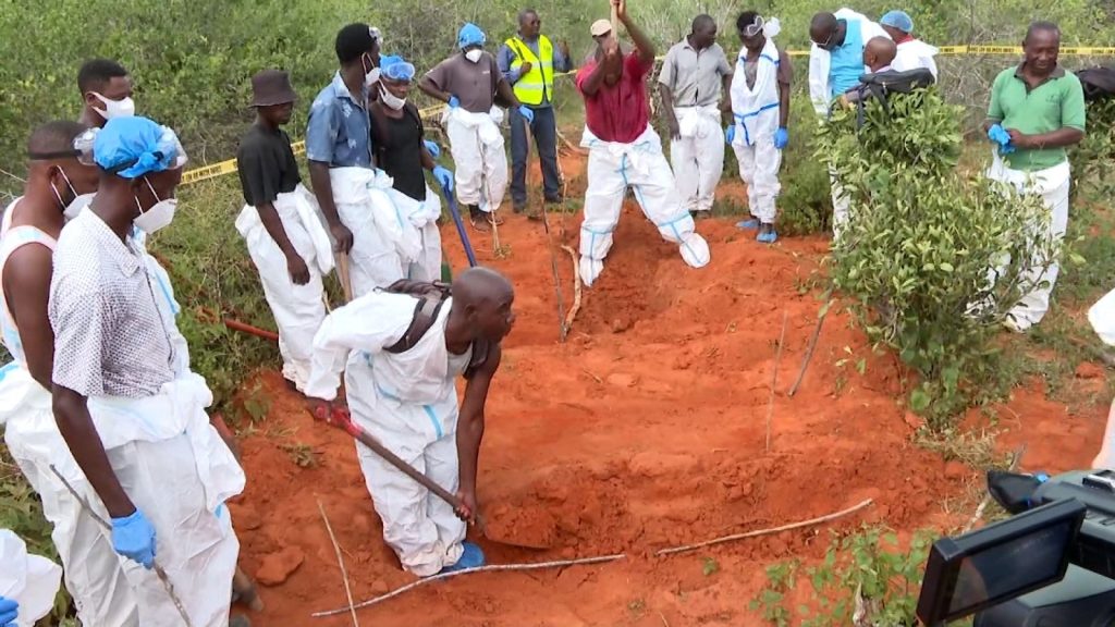 Workers in protective gear dig mass graves in Kenya's Shakahola Forest, site of the 2023 starvation cult massacre.
