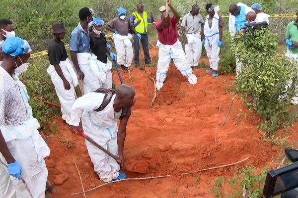 Workers in protective gear dig mass graves in Kenya's Shakahola Forest, site of the 2023 starvation cult massacre.